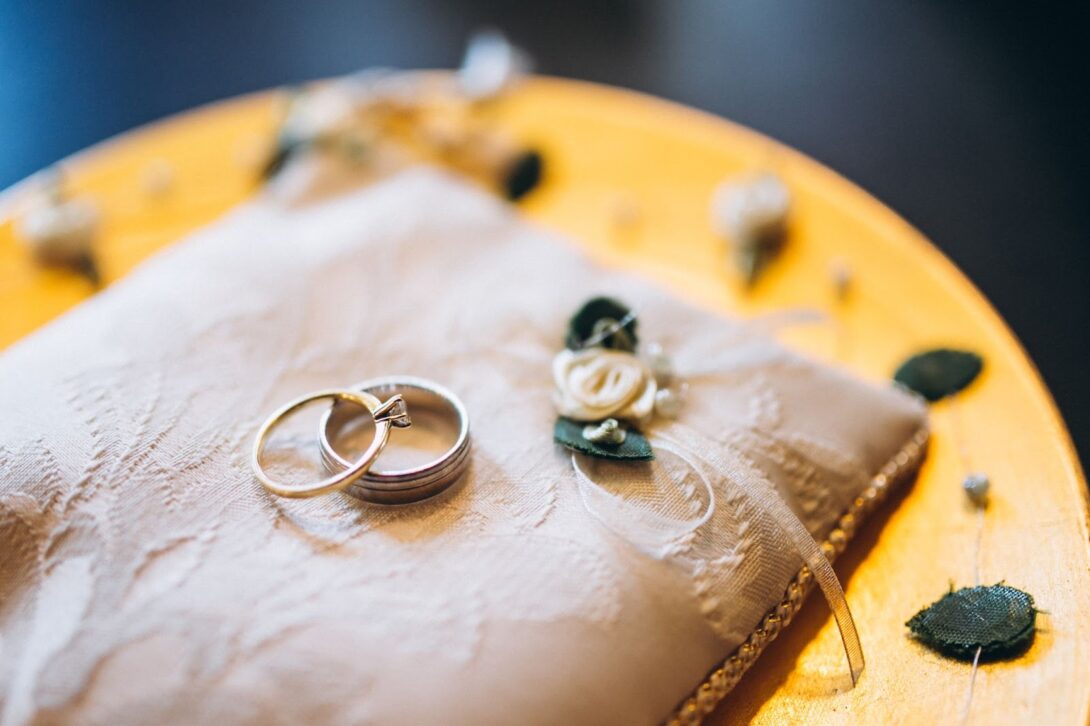 Close up of wedding rings on cushion